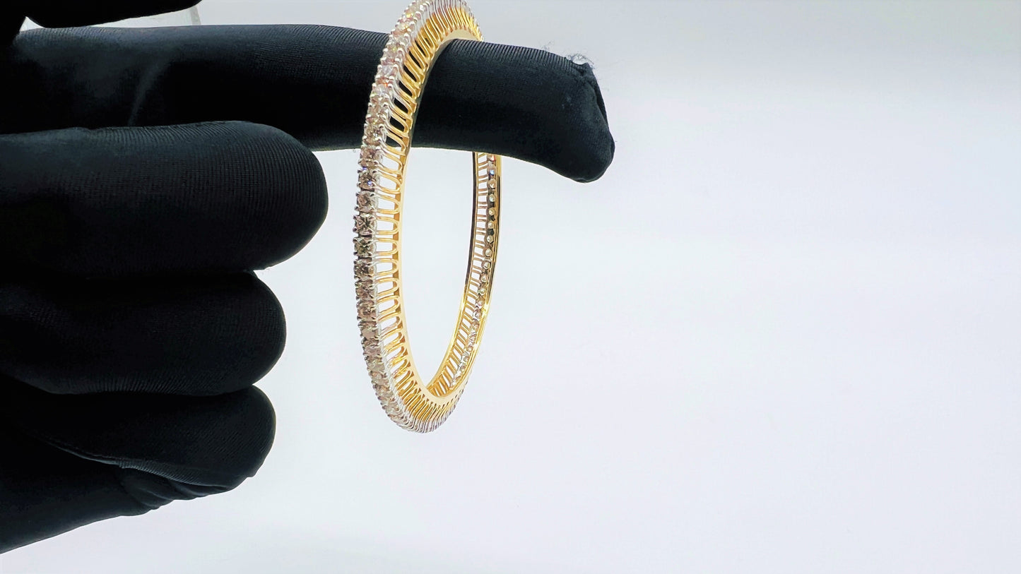 A beautiful gold diamond bangle pair with neatly set sparkling diamonds all around. The elegant design gives a timeless and classy look, making it perfect for everyday wear or special occasions.