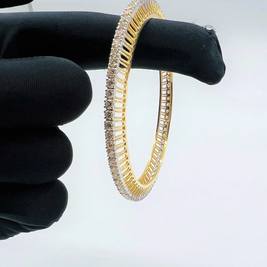 A beautiful gold diamond bangle pair with neatly set sparkling diamonds all around. The elegant design gives a timeless and classy look, making it perfect for everyday wear or special occasions.
