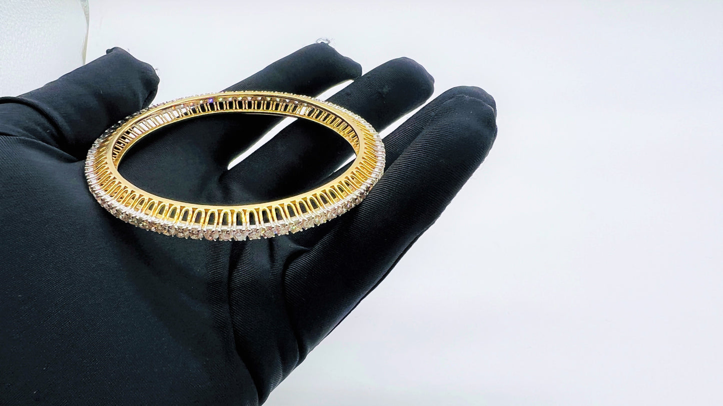 A beautiful gold diamond bangle pair with neatly set sparkling diamonds all around. The elegant design gives a timeless and classy look, making it perfect for everyday wear or special occasions.