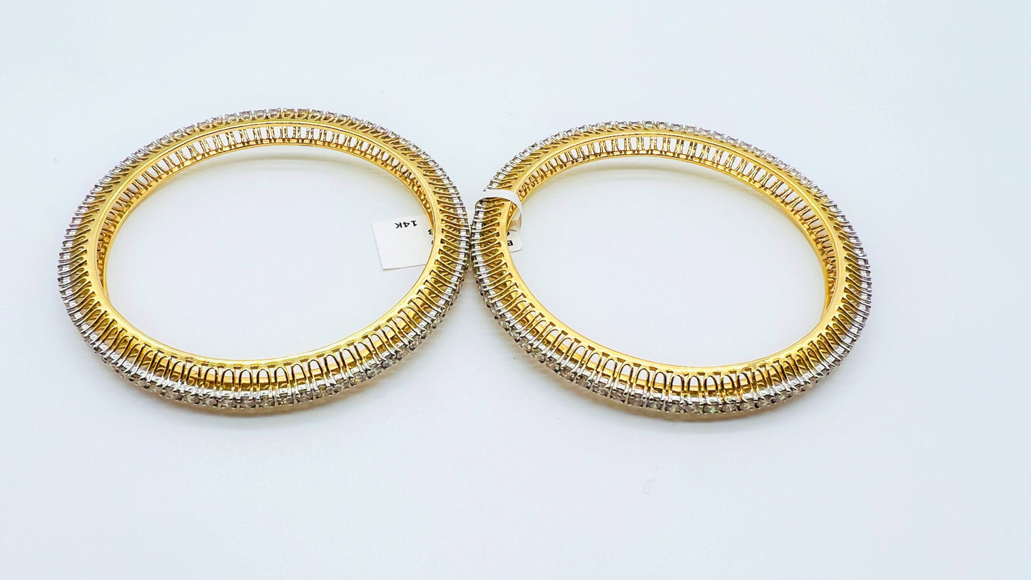 A beautiful gold diamond bangle pair with neatly set sparkling diamonds all around. The elegant design gives a timeless and classy look, making it perfect for everyday wear or special occasions.