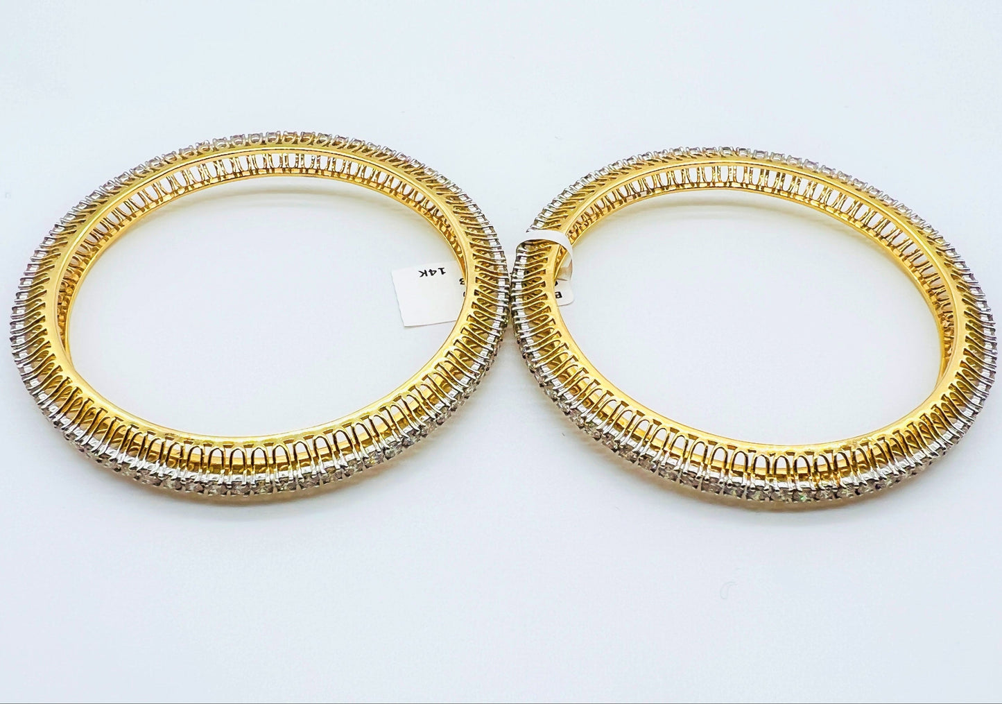 A beautiful gold diamond bangle pair with neatly set sparkling diamonds all around. The elegant design gives a timeless and classy look, making it perfect for everyday wear or special occasions.