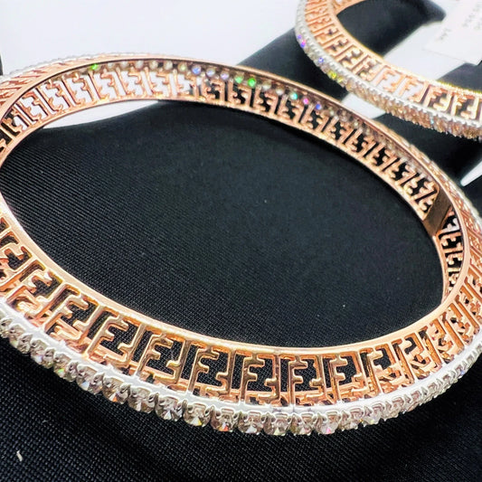 Side view of rose gold diamond bangle set featuring fine diamond lining and modern cutwork design in 14k gold.