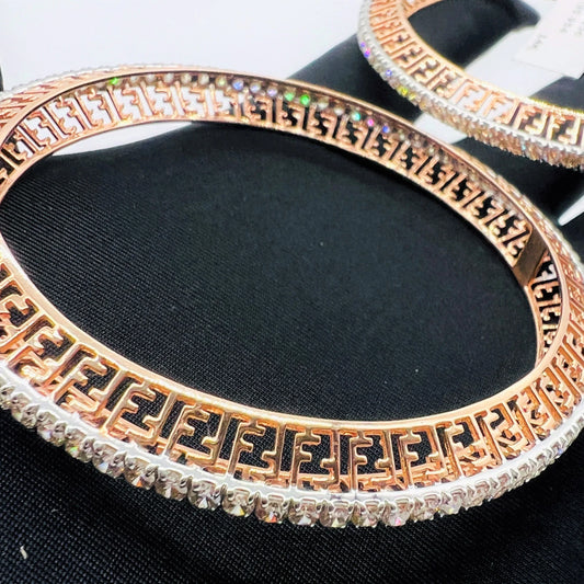 Side view of rose gold diamond bangle set featuring fine diamond lining and modern cutwork design in 14k gold.