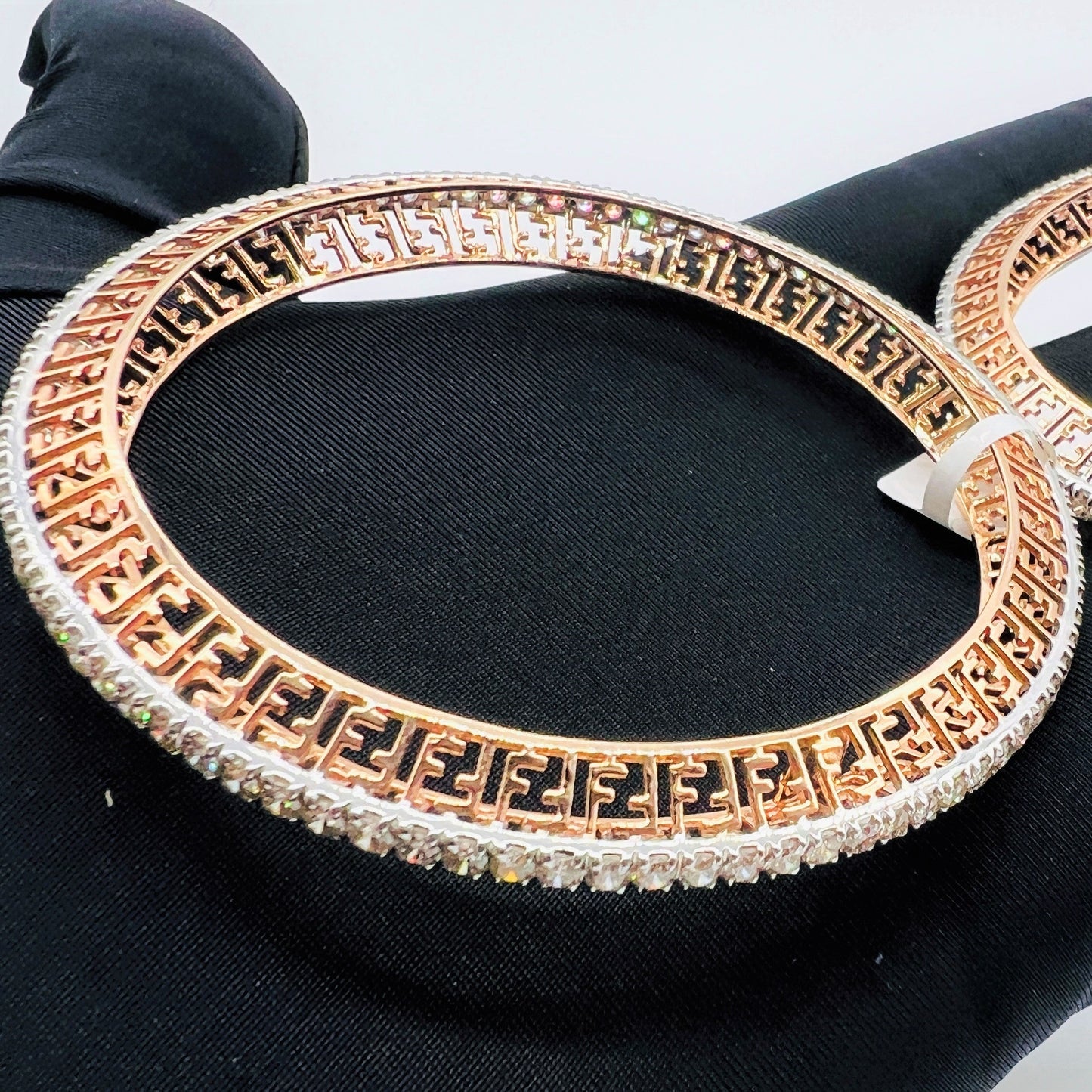Side view of rose gold diamond bangle set featuring fine diamond lining and modern cutwork design in 14k gold.