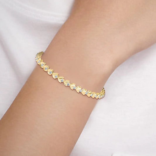 Gold diamond bracelet on a person's wrist with a white background