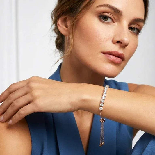 Woman wearing a real diamond bracelet on a plain background