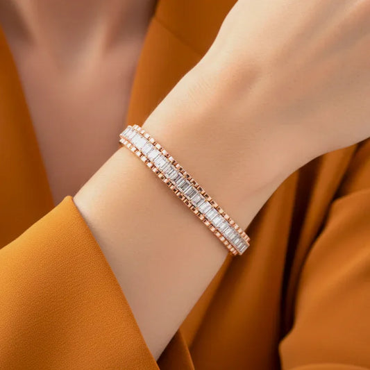 Rose gold bracelet with real diamonds on a wrist against an orange background