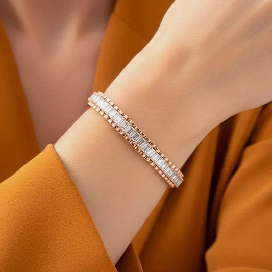 Rose gold bracelet with real diamonds on a wrist against an orange background