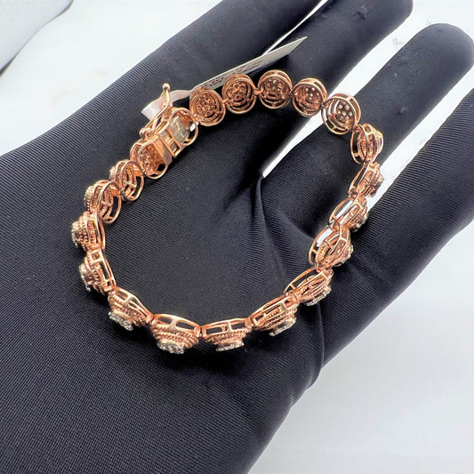 A gold diamond bracelet with multiple rows of inset stones, displayed on a mannequin hand.