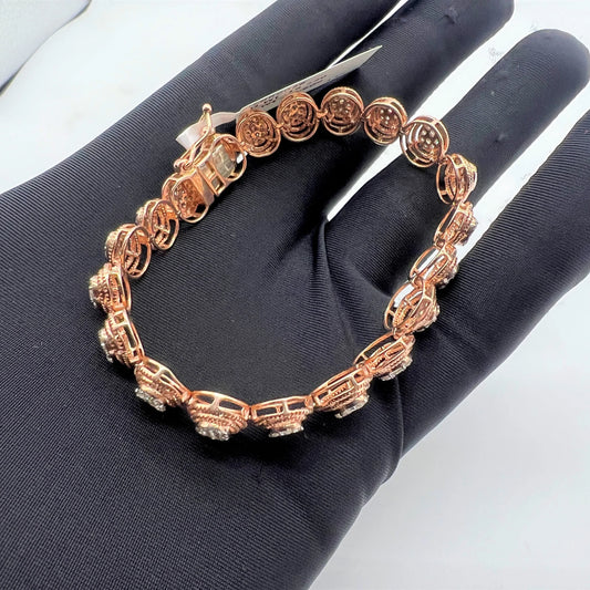 A gold diamond bracelet with multiple rows of inset stones, displayed on a mannequin hand.