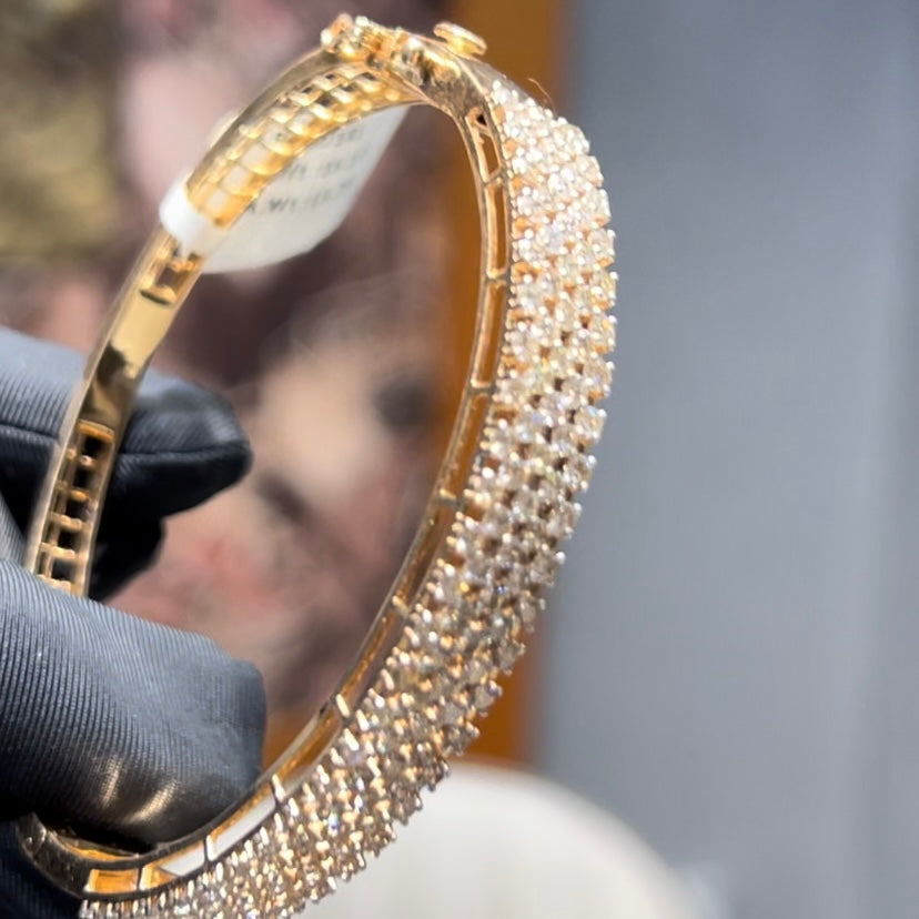 Elegant pavé set gold diamond bracelet with multiple rows of sparkling round-cut diamonds.