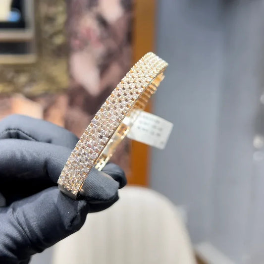 Elegant pavé set gold diamond bracelet with multiple rows of sparkling round-cut diamonds.