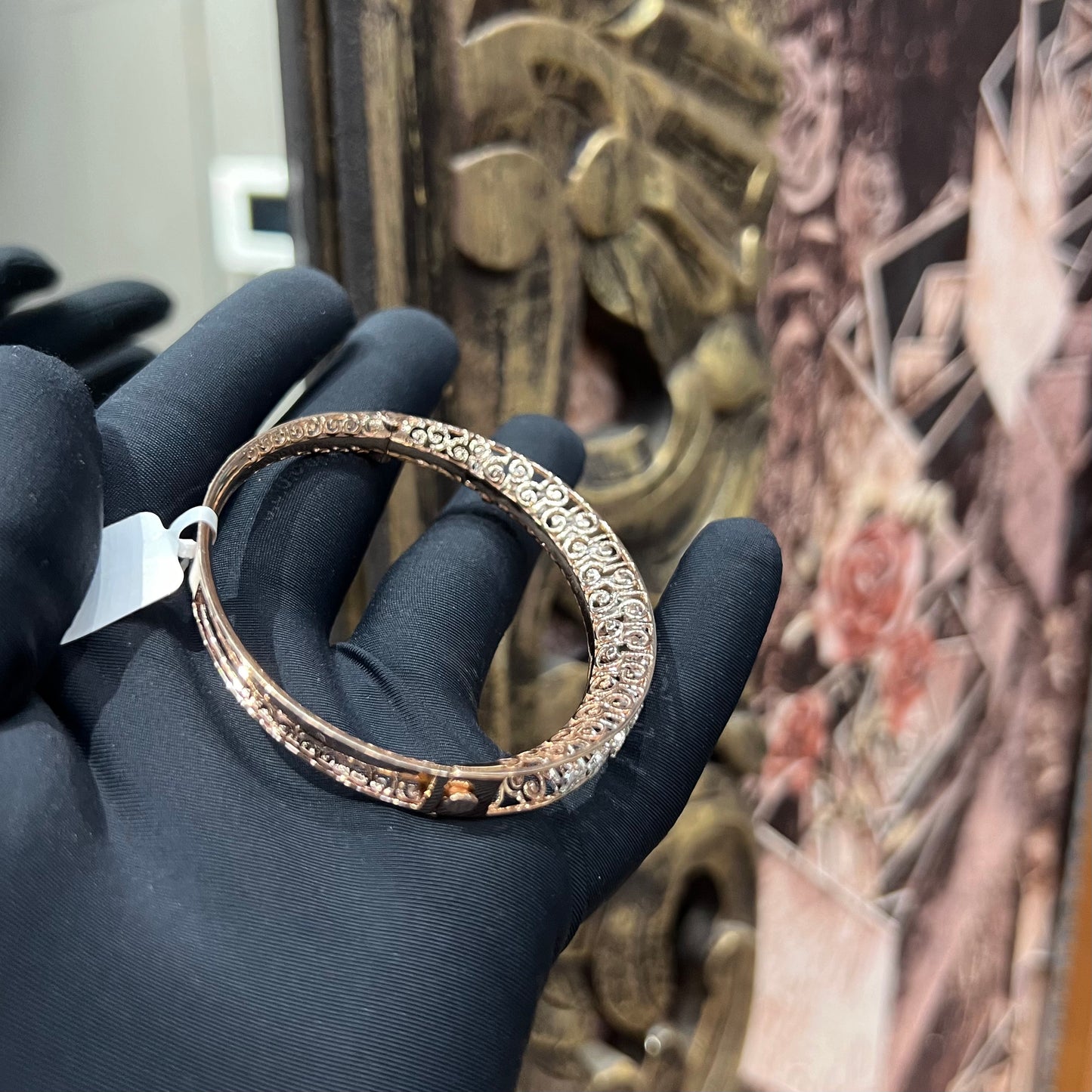 Elegant rose gold diamond bracelet with round-cut diamonds in a bangle design, displayed on a hand.