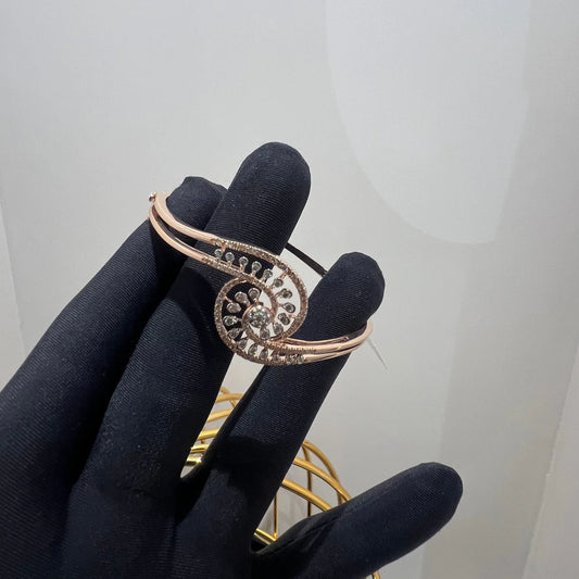 A luxurious gold diamond bracelet with a openable design, featuring a central oval-shaped diamond surrounded by smaller diamonds set in a brilliant cut, displayed on a mannequin hand.