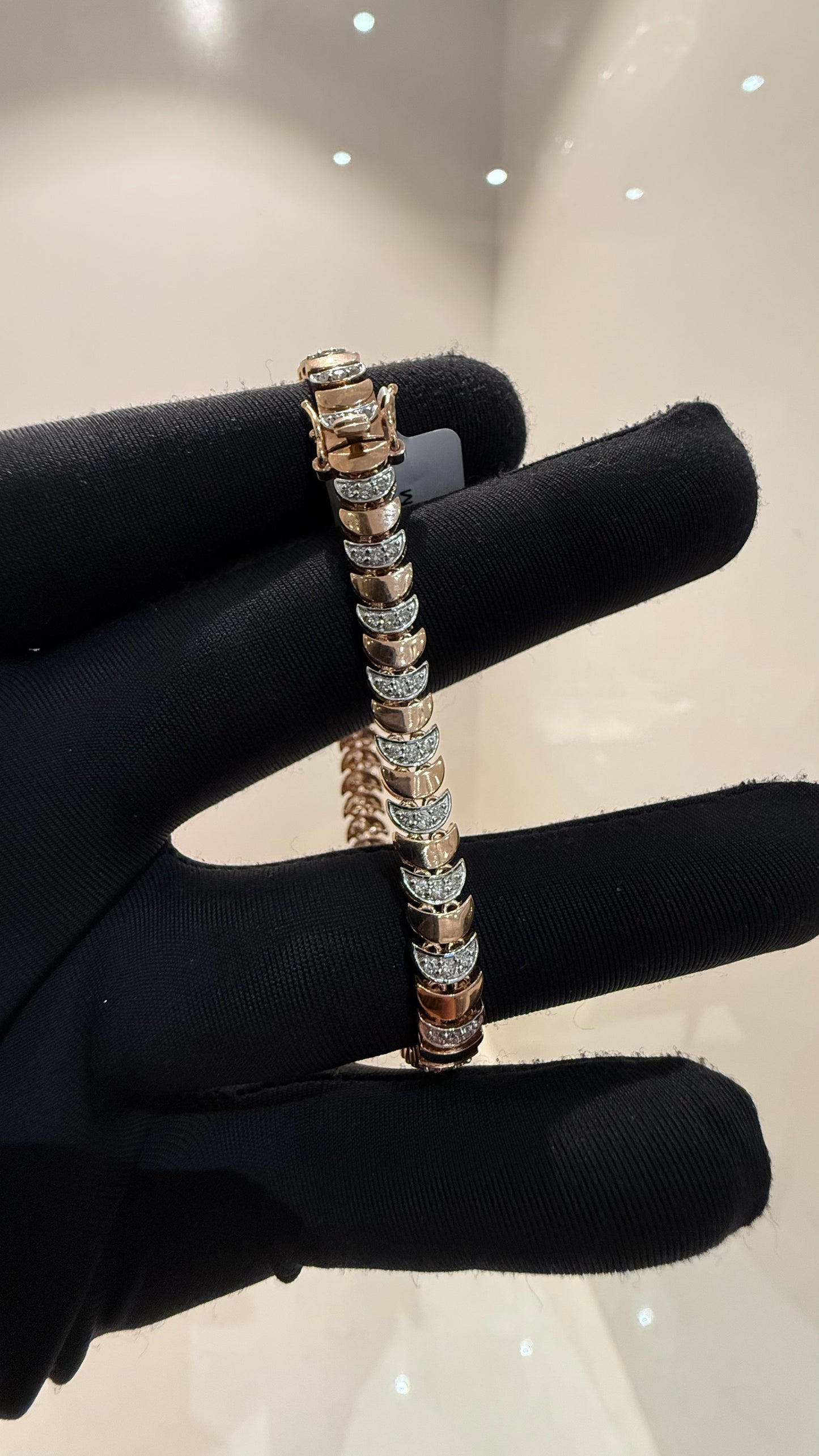 Elegant gold diamond bracelet crafted with unique crescent links and sparkling pavé-set diamonds.