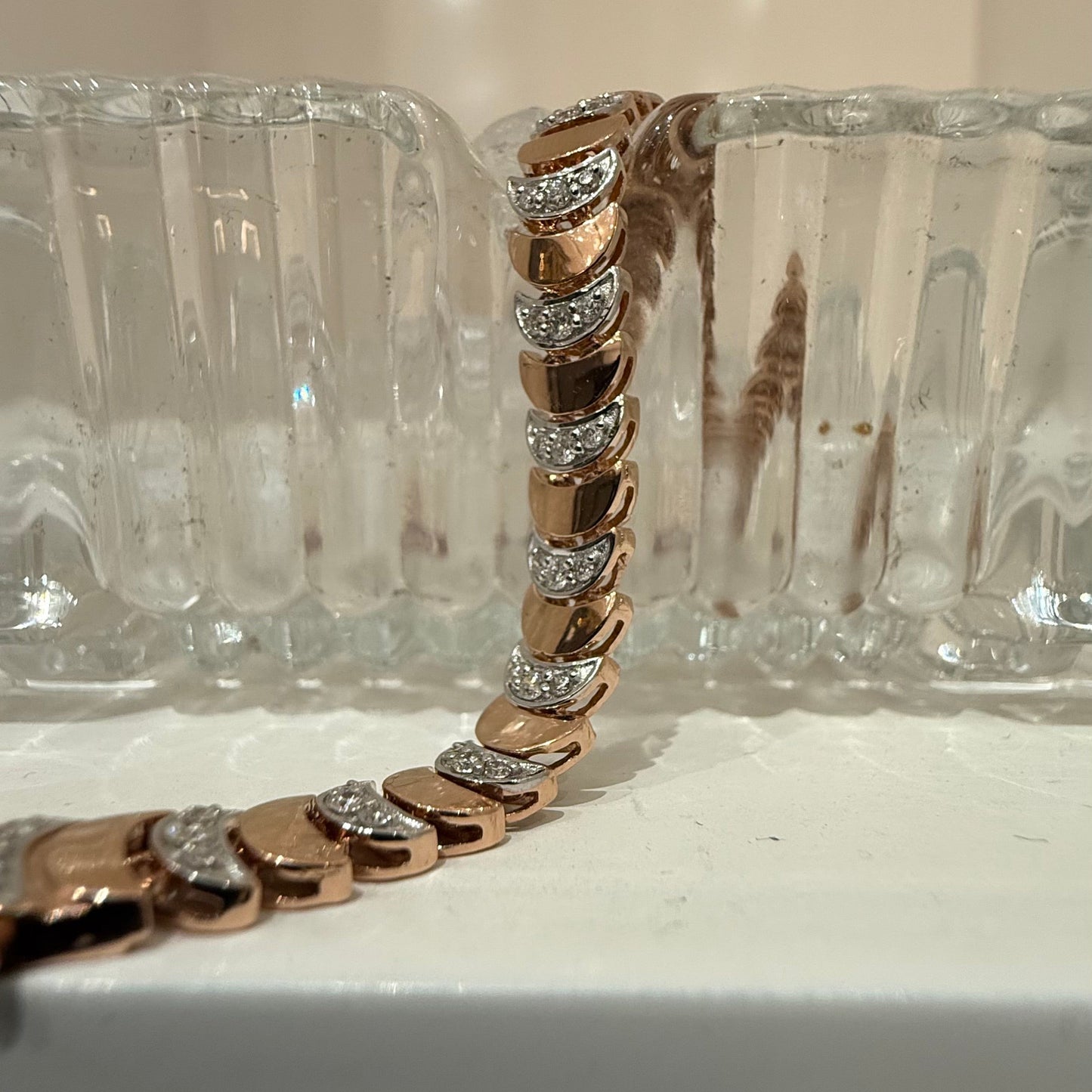 Elegant gold diamond bracelet crafted with unique crescent links and sparkling pavé-set diamonds.