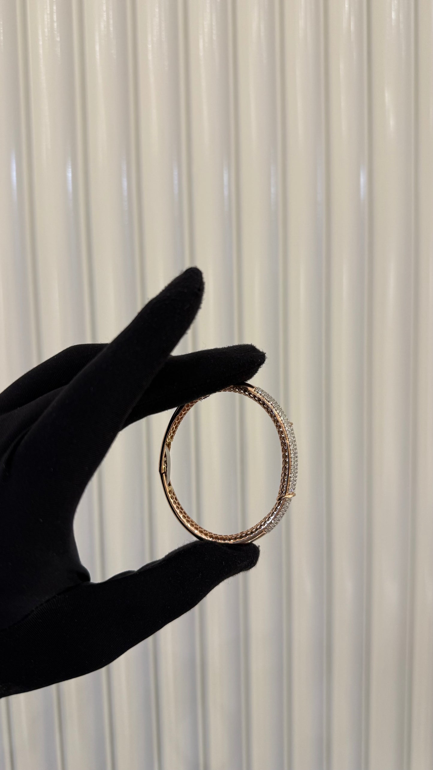 Luxury gold diamond bracelet featuring multiple rows of sparkling diamonds in a stylish cuff shape.