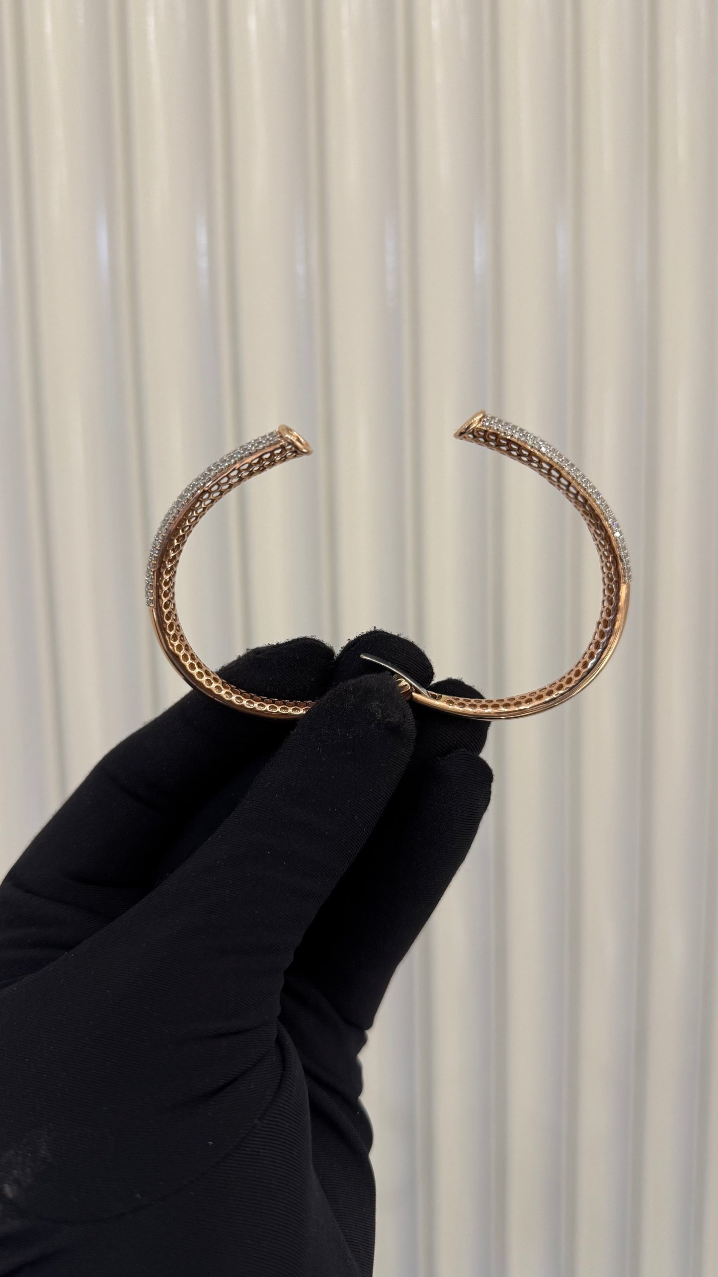 Luxury gold diamond bracelet featuring multiple rows of sparkling diamonds in a stylish cuff shape.