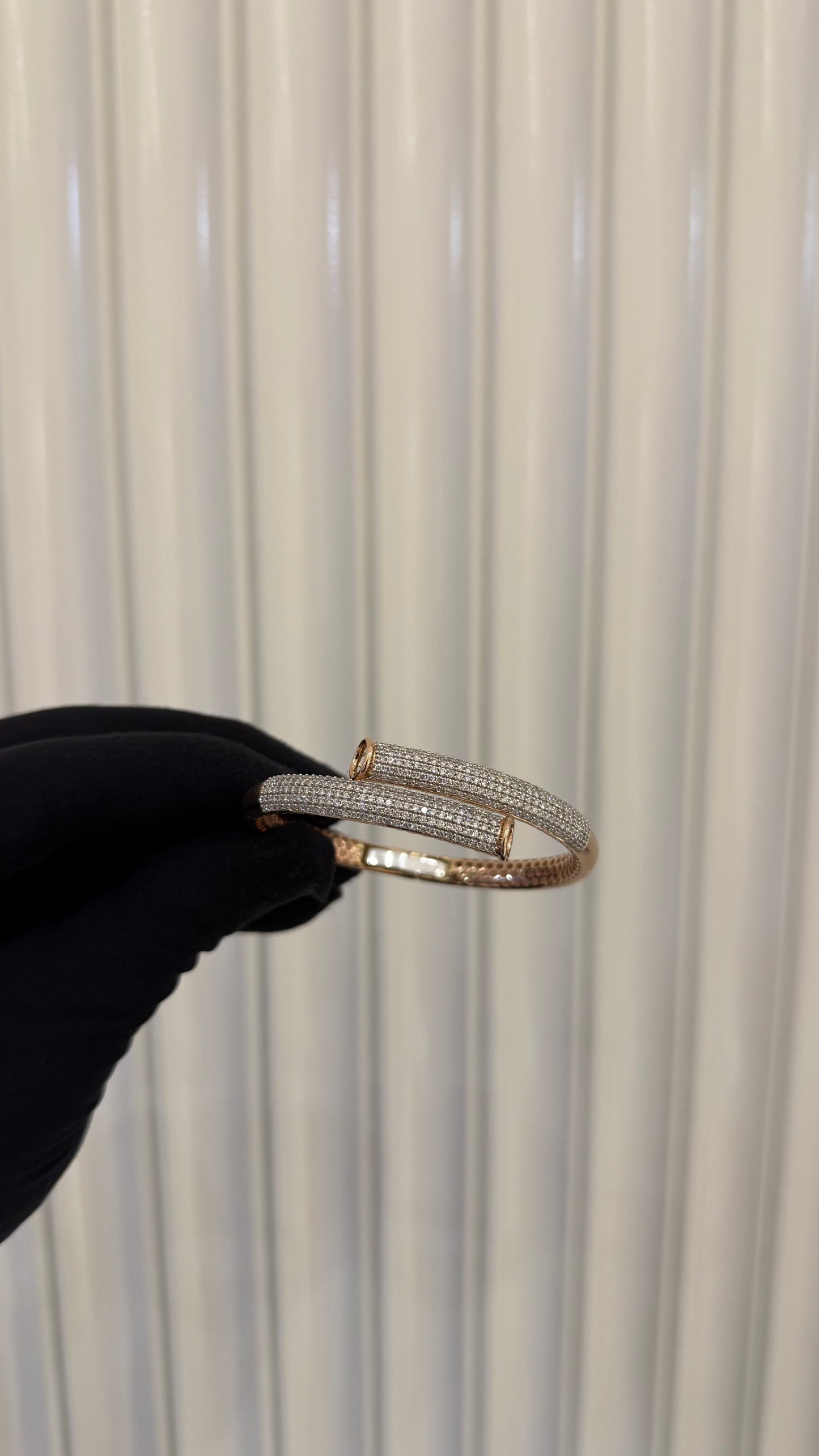 Luxury gold diamond bracelet featuring multiple rows of sparkling diamonds in a stylish cuff shape.