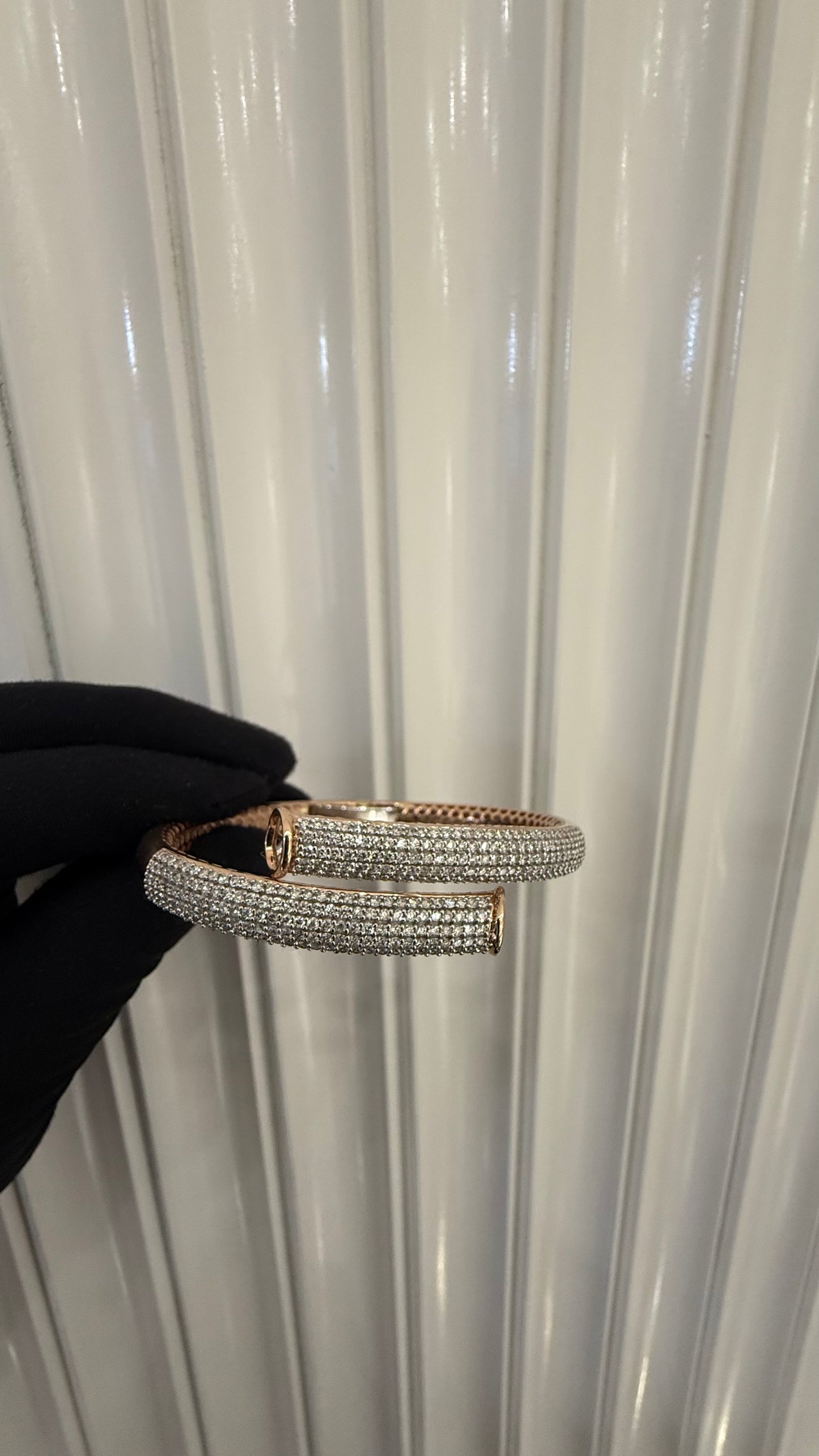 Luxury gold diamond bracelet featuring multiple rows of sparkling diamonds in a stylish cuff shape.