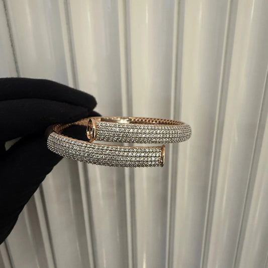 Luxury gold diamond bracelet featuring multiple rows of sparkling diamonds in a stylish cuff shape.