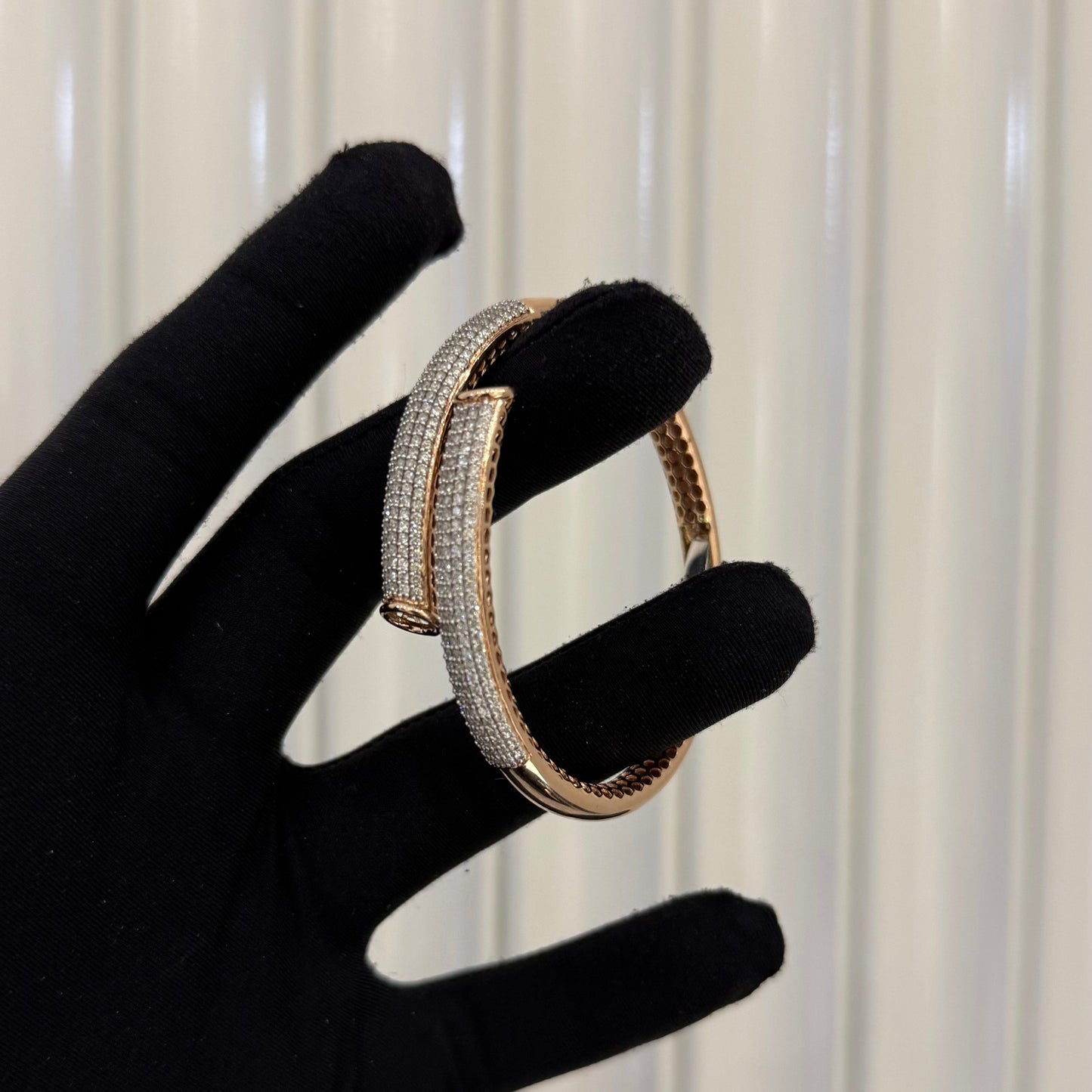 Luxury gold diamond bracelet featuring multiple rows of sparkling diamonds in a stylish cuff shape.