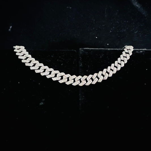 Stylish diamond Cuban chain bracelet with pavé-set diamonds, featuring bold interlocking links for a luxury statement look.