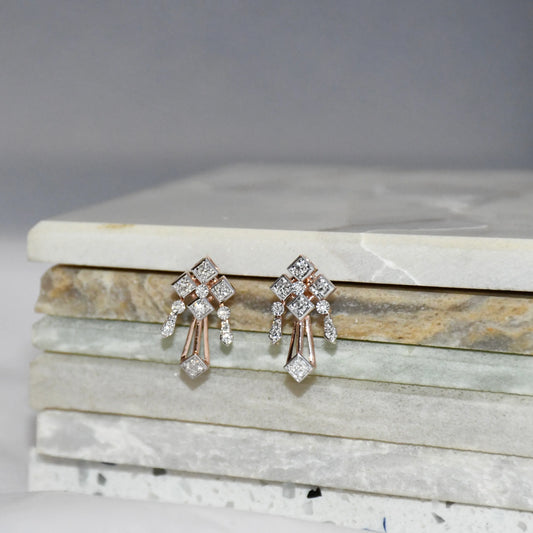 Pair of diamond earrings on a marble surface