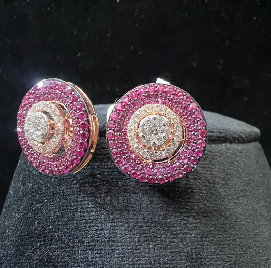 A pair of gold diamond stud earrings with a rose gold band on a black mannequin.