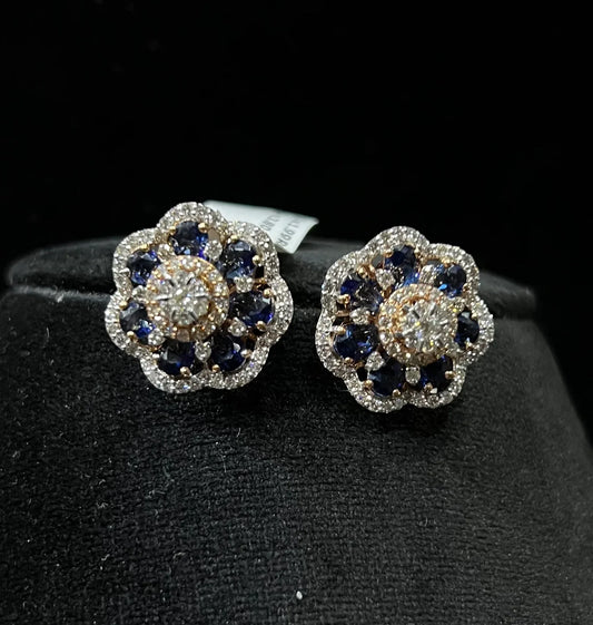 Close-up of natural blue stone and diamond earrings in a floral stud design, crafted in gold – elegant women’s diamond earrings.