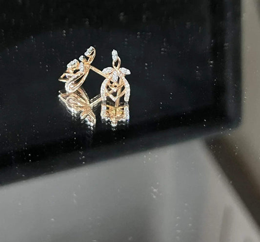 A pair of diamond earrings with a rose gold or gold color finish, featuring a V-shaped design with diamond embellishments.