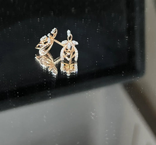 A pair of diamond earrings with a rose gold or gold color finish, featuring a V-shaped design with diamond embellishments.
