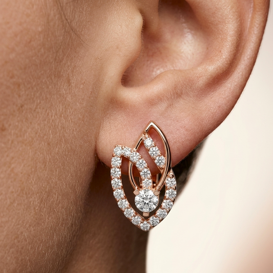Rose gold earring with real diamonds worn on an ear against a neutral background