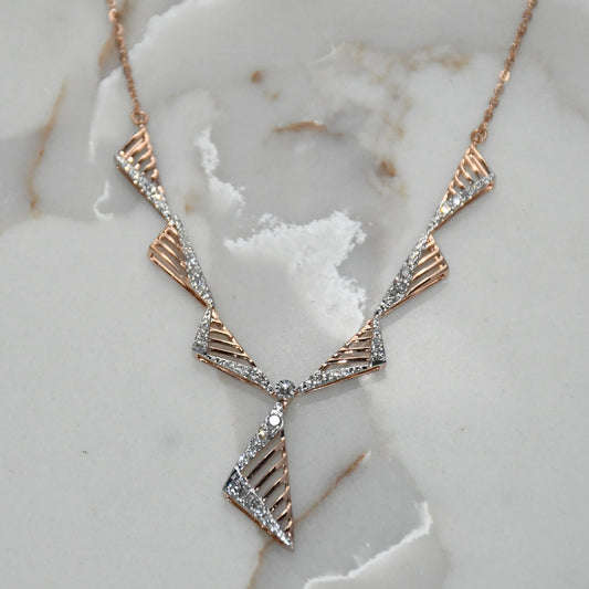 gold and diamond necklace on a marble surface