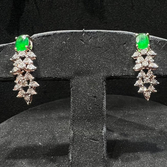 Designer diamond color stone earrings displayed on a mannequin bust.