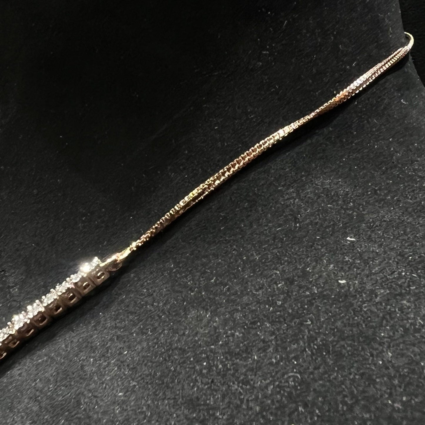 Designer diamond necklace set from side angle is displayed on a mannequin bust.