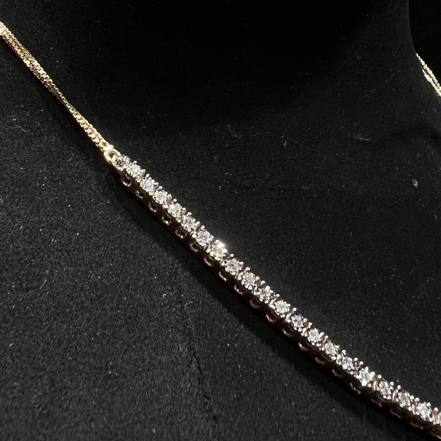 Designer diamond necklace set from side angle is displayed on a mannequin bust.