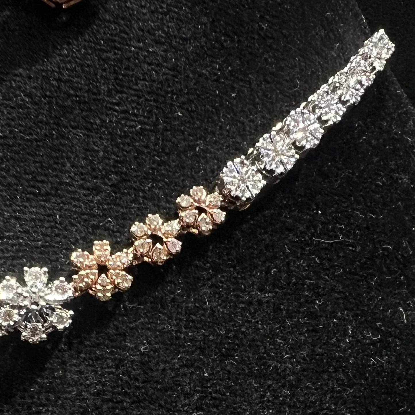 Floral design diamond necklace set with matching earrings, featuring a pear-shaped blue stone drop surrounded by natural diamonds.