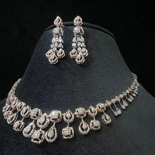 A 14K gold diamond necklace and earrings set displayed on a mannequin bust, featuring a solid gold structure with diamond encrusted in the earrings and necklace.