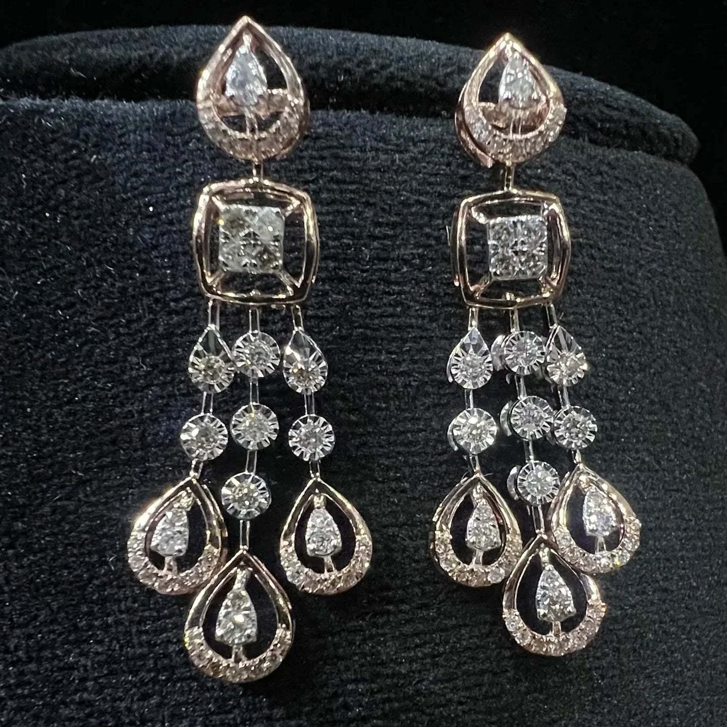 gold diamond earrings set displayed on a mannequin bust, featuring a solid gold structure with diamond encrusted in the earrings.