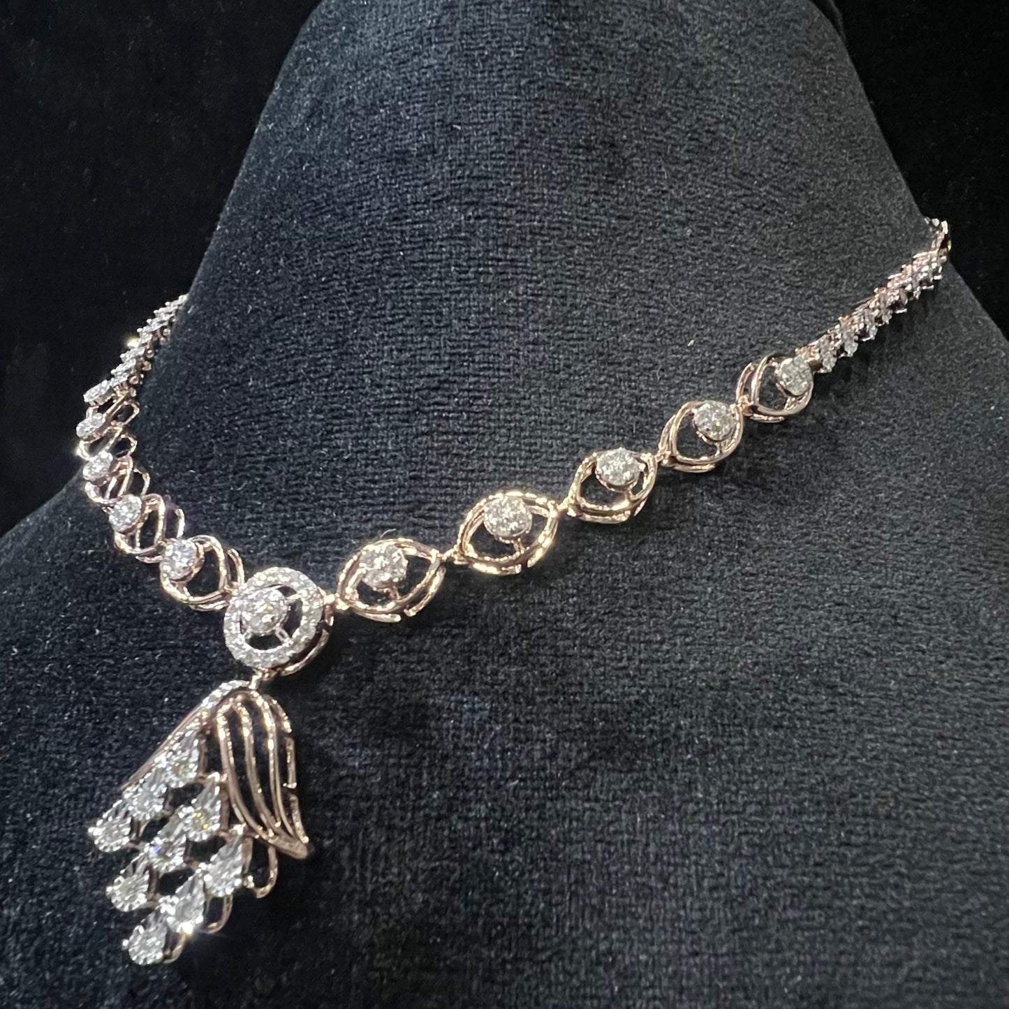 Radiant cascade diamond necklace set displayed on black velvet bust