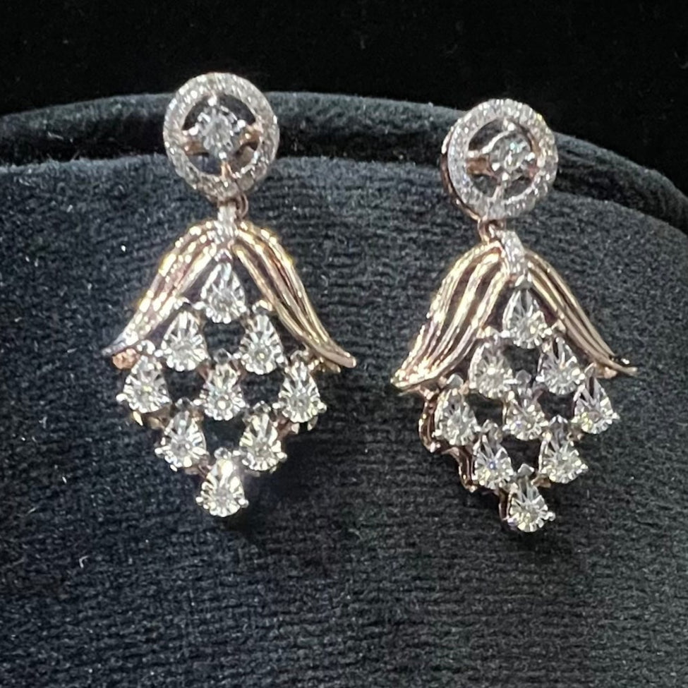 Radiant cascade diamond earrings displayed on black velvet bust