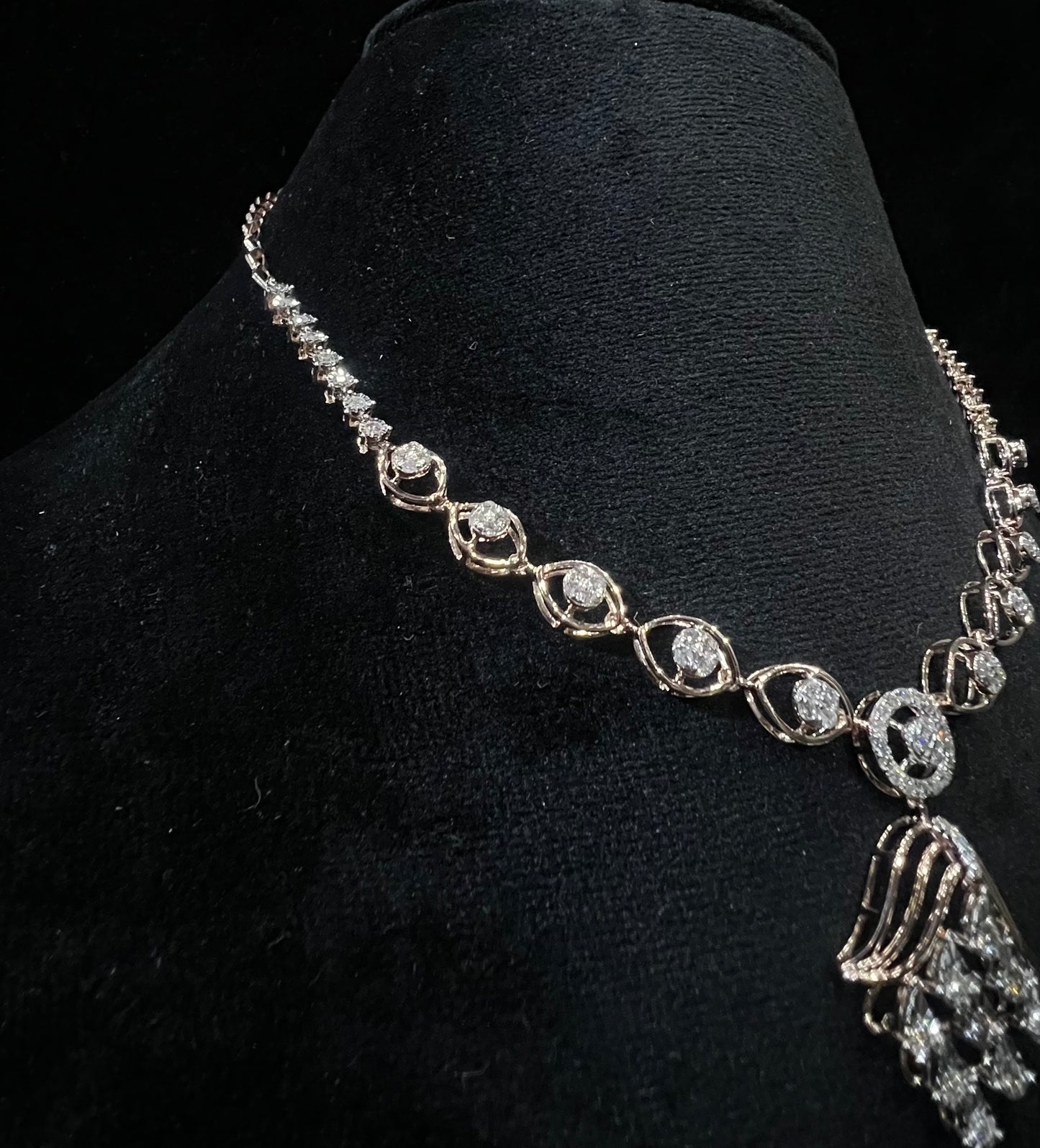 Radiant cascade diamond necklace set displayed on black velvet bust