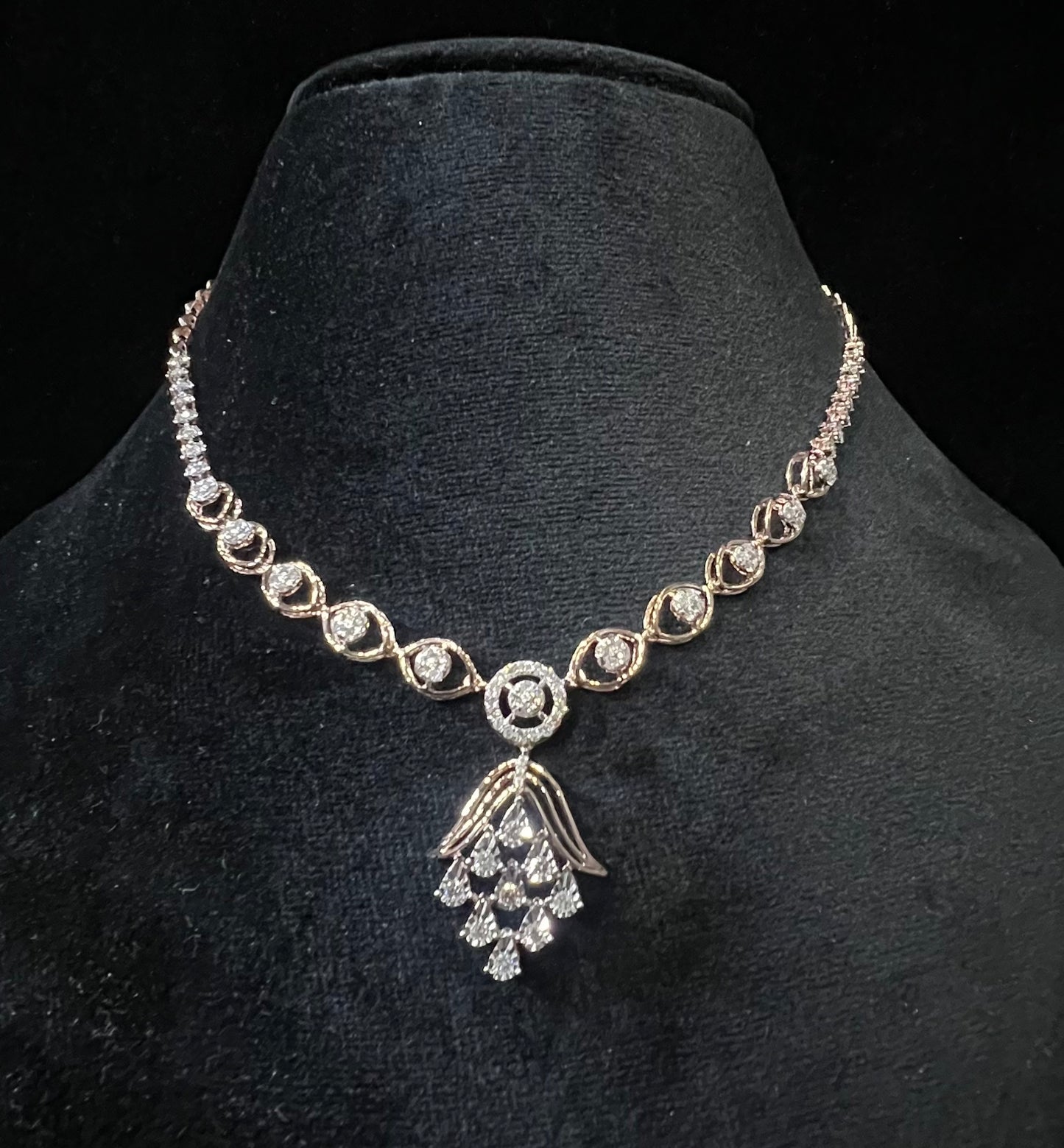 Radiant cascade diamond necklace set displayed on black velvet bust