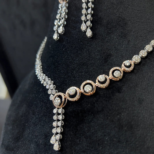 Diamond necklace set with circular motif design and matching drop earrings, featuring sparkling stones in elegant modern style.
