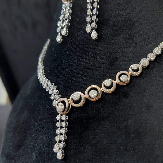 Diamond necklace set with circular motif design and matching drop earrings, featuring sparkling stones in elegant modern style.