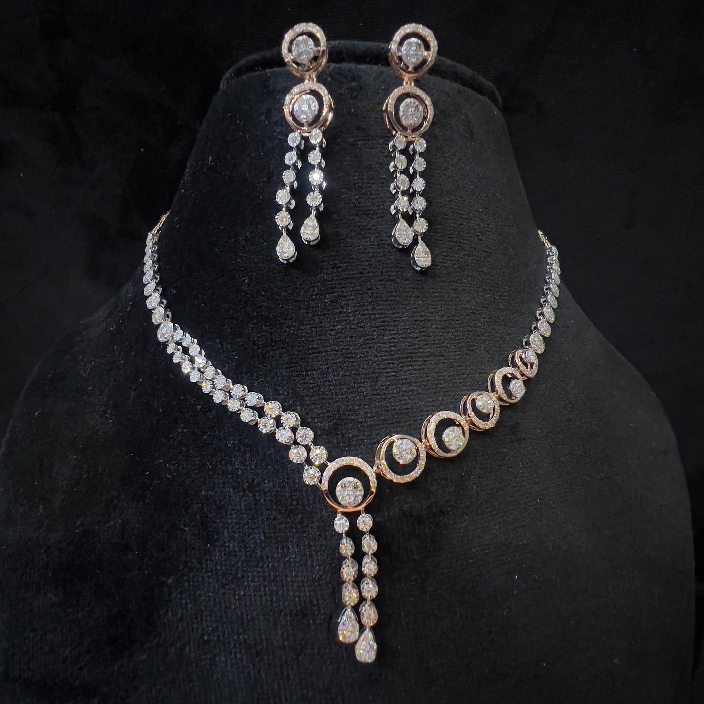Diamond necklace set with circular motif design and matching drop earrings, featuring sparkling stones in elegant modern style.