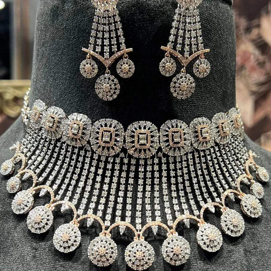 A gold diamond choker necklace with a matching set of earrings, adorned with brilliant cut diamonds, displayed on a mannequin.