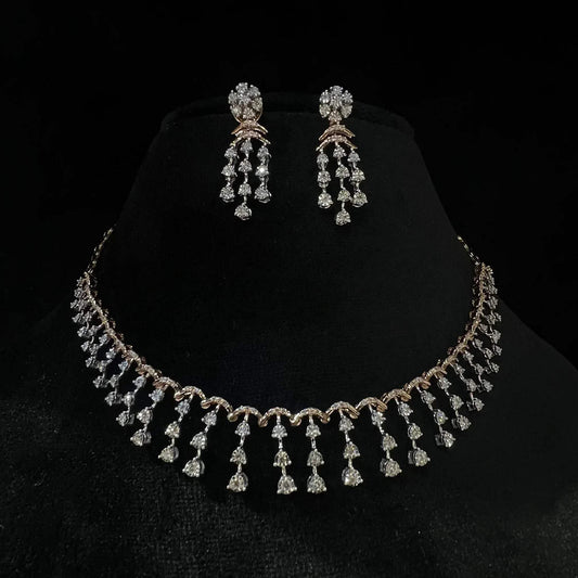 A gold diamond necklace with a series of round and marquise shaped earrings attached to the neckline, set on a black mannequin.