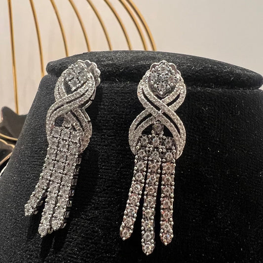 Eternal Knot Cascade diamond earrings featuring layered diamond strands displayed on a mannequin.